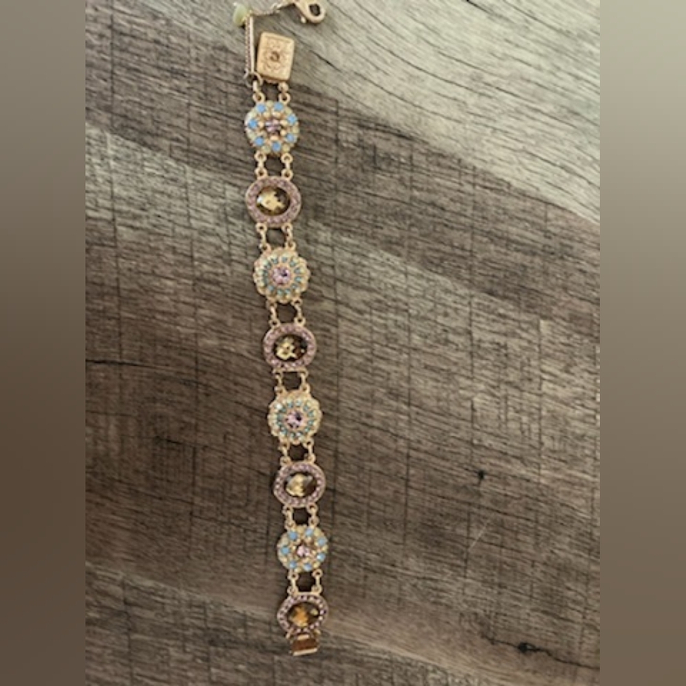 Mariana rose gold, pinkish purple stones with light teal color blue